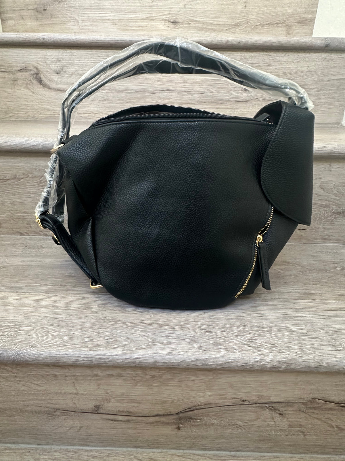 Black asymmetrical coverable handbag to backpack